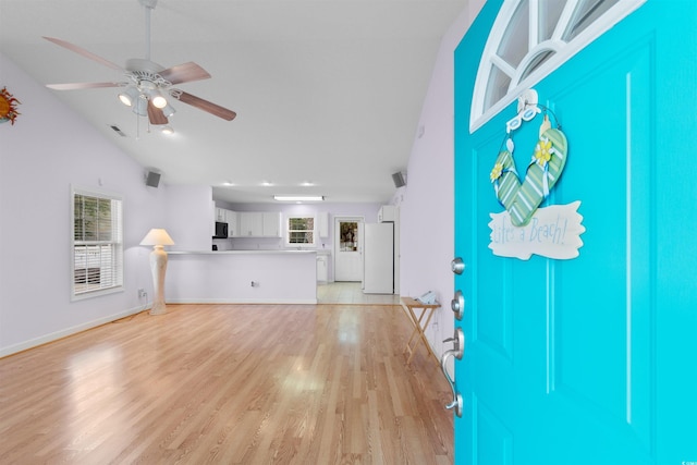 613B 3rd Ave S, North Myrtle Beach, SC 29582 - unfurnished living room with light wood-type flooring, a ceiling fan, lofted ceiling, and baseboards