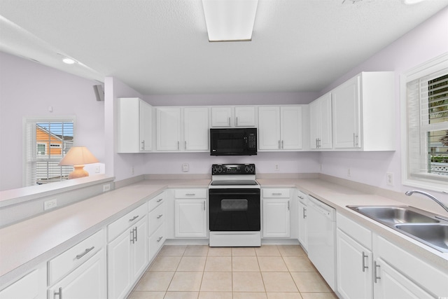 613B 3rd Ave S, North Myrtle Beach, SC 29582 - kitchen featuring white appliances, a sink, white cabinets, light countertops, and recessed lighting