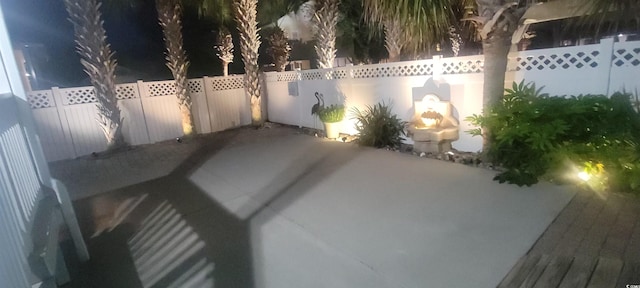 613B 3rd Ave S, North Myrtle Beach, SC 29582 - patio at twilight featuring a patio area and a fenced backyard