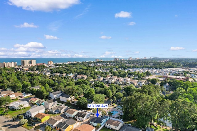 613B 3rd Ave S, North Myrtle Beach, SC 29582 - aerial view of property and surrounding area with a nearby body of water, a tree filled landscape, and nearby suburban area