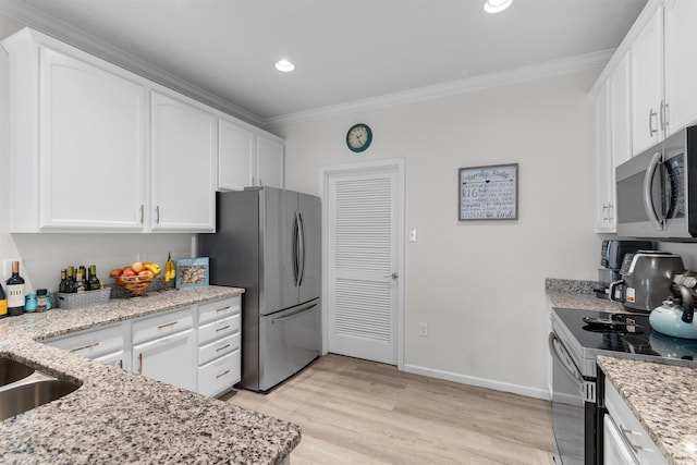 411 Mahogany Dr Unit 101, Murrells Inlet, SC 29576 - kitchen featuring stainless steel appliances, crown molding, white cabinets, light stone counters, and light wood-style floors