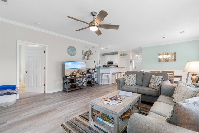 411 Mahogany Dr Unit 101, Murrells Inlet, SC 29576 - living room featuring a chandelier, crown molding, light wood finished floors, a ceiling fan, and baseboards