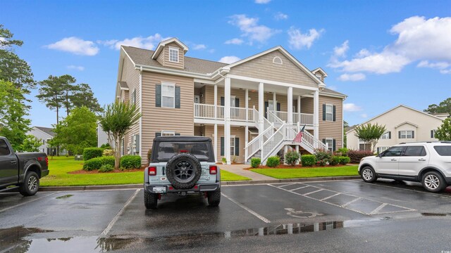 411 Mahogany Dr Unit 101, Murrells Inlet, SC 29576 - view of property with stairs and uncovered parking