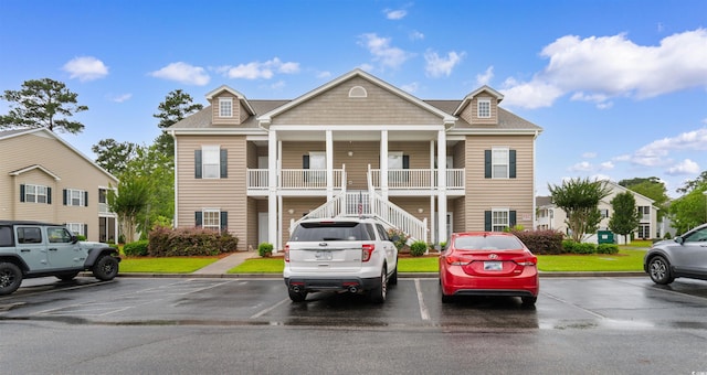411 Mahogany Dr Unit 101, Murrells Inlet, SC 29576 - view of front facade with stairs, uncovered parking, and covered porch