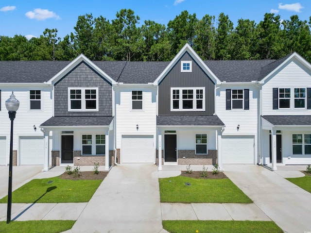 776 NW Palm Frond Way Unit 55, Calabash, NC 28467 - view of front of home featuring brick siding, driveway, and a porch