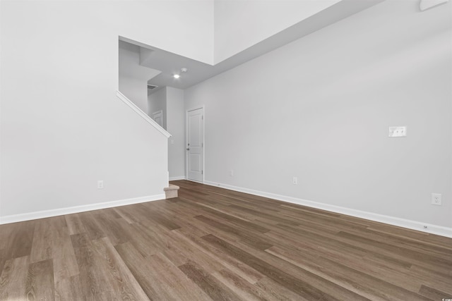 776 NW Palm Frond Way Unit 55, Calabash, NC 28467 - unfurnished room featuring wood finished floors, baseboards, and stairway
