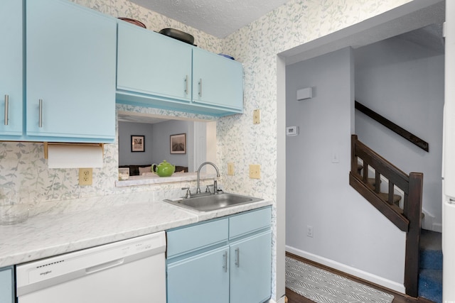 614 15th Ave S Unit 41, Surfside Beach, SC 29575 - kitchen featuring white dishwasher, blue cabinets, wallpapered walls, light countertops, and a textured ceiling