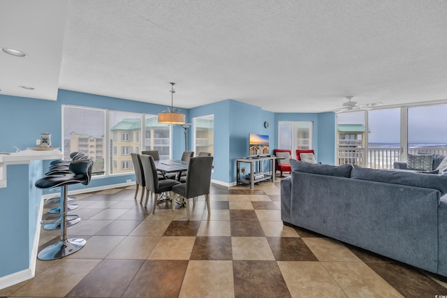 135 S Dunes Dr Unit 501, Pawleys Island, SC 29585 - living area featuring baseboards, a textured ceiling, and ceiling fan
