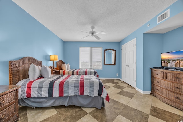 135 S Dunes Dr Unit 501, Pawleys Island, SC 29585 - bedroom featuring baseboards, a closet, ceiling fan, and a textured ceiling