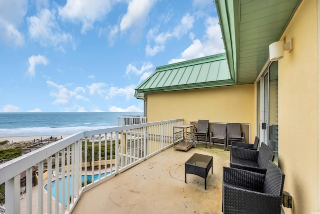 135 S Dunes Dr Unit 501, Pawleys Island, SC 29585 - balcony featuring view of water and beach, view of pool, and an outdoor hangout area