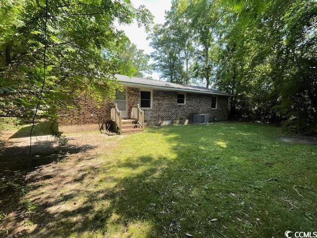 41 Harmon St, Hemingway, SC 29554 - rear view of house featuring a lawn and brick siding