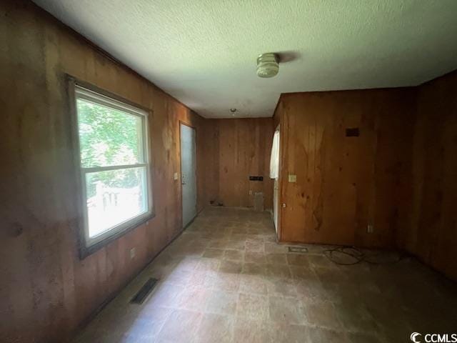 41 Harmon St, Hemingway, SC 29554 - spare room with wood walls and a textured ceiling