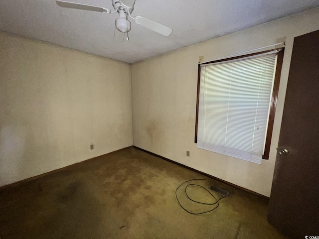 41 Harmon St, Hemingway, SC 29554 - unfurnished room featuring ceiling fan and dark colored carpet