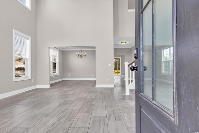 5621 Camilla Ct, Myrtle Beach, SC 29579 - entrance foyer with a towering ceiling, a chandelier, crown molding, plenty of natural light, and baseboards