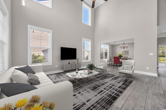 5621 Camilla Ct, Myrtle Beach, SC 29579 - living room featuring a high ceiling, a chandelier, baseboards, and ceiling fan