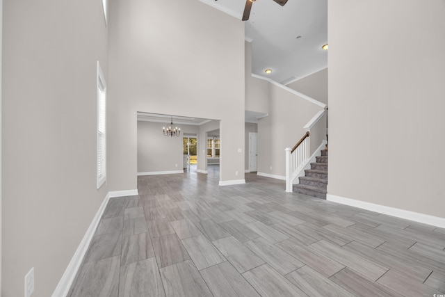 5621 Camilla Ct, Myrtle Beach, SC 29579 - unfurnished living room featuring a chandelier, stairs, a towering ceiling, ceiling fan, and baseboards
