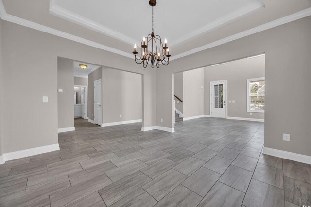 5621 Camilla Ct, Myrtle Beach, SC 29579 - spare room with a raised ceiling, stairs, ornamental molding, a chandelier, and baseboards