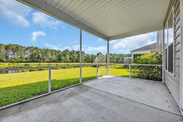 5621 Camilla Ct, Myrtle Beach, SC 29579 - unfurnished sunroom featuring view of wooded area and a water view