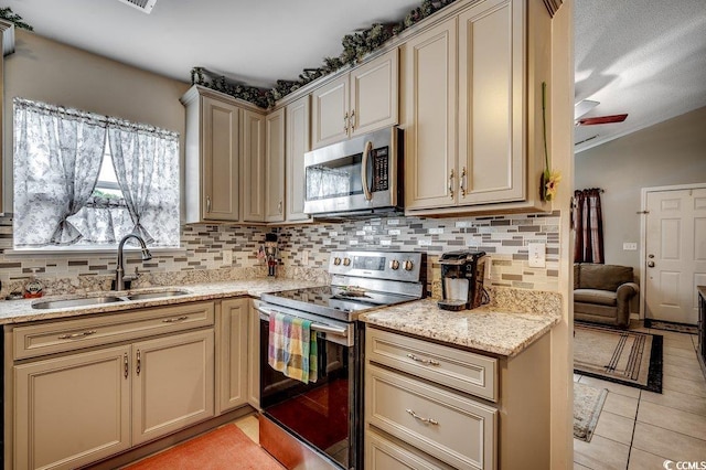 403 Chesterfield Ct, Myrtle Beach, SC 29577 - kitchen featuring stainless steel appliances, cream cabinetry, backsplash, and a sink