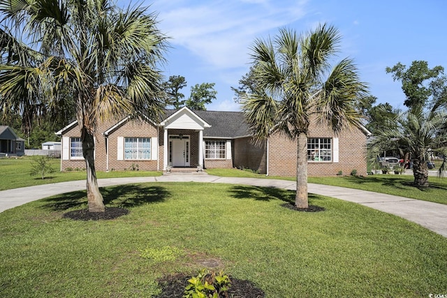 2981 Victor Rd, Longs, SC 29568 - ranch-style home featuring brick siding, curved driveway, and a front lawn