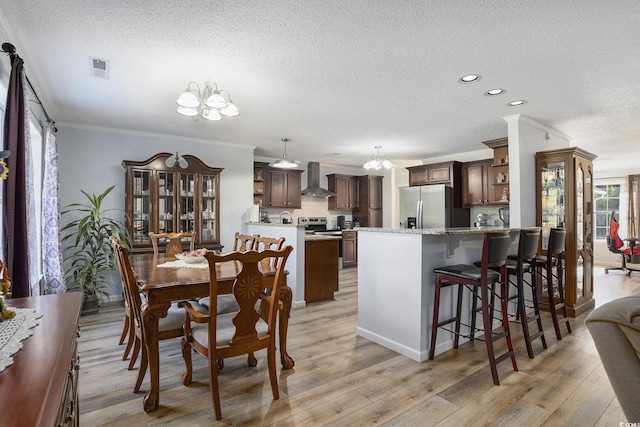 2981 Victor Rd, Longs, SC 29568 - dining room with a chandelier, a textured ceiling, crown molding, light wood-style floors, and recessed lighting