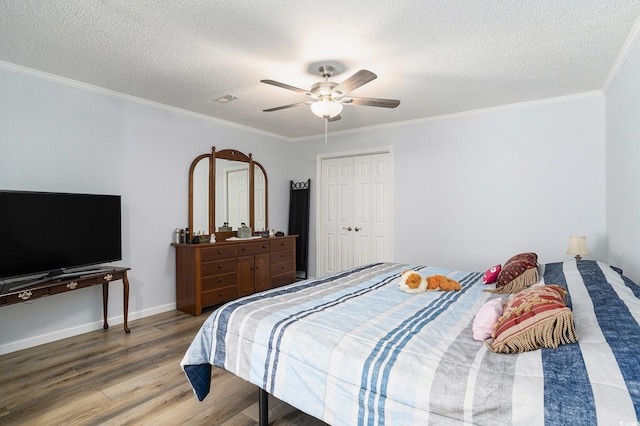 2981 Victor Rd, Longs, SC 29568 - bedroom featuring wood finished floors, a textured ceiling, a ceiling fan, ornamental molding, and a closet