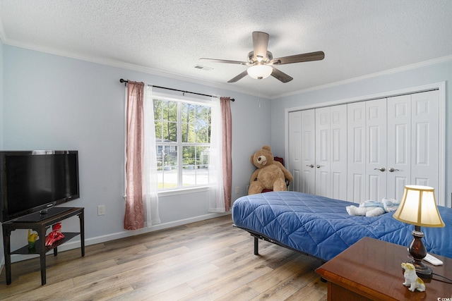 2981 Victor Rd, Longs, SC 29568 - bedroom featuring light wood-type flooring, crown molding, a textured ceiling, baseboards, and a closet