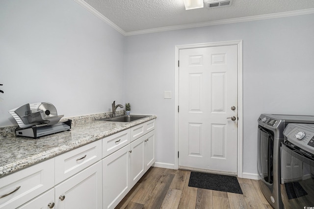 2981 Victor Rd, Longs, SC 29568 - washroom featuring washer and dryer, cabinet space, wood finished floors, ornamental molding, and a textured ceiling