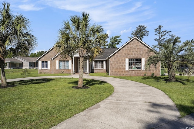 2981 Victor Rd, Longs, SC 29568 - single story home featuring brick siding, curved driveway, and a front lawn