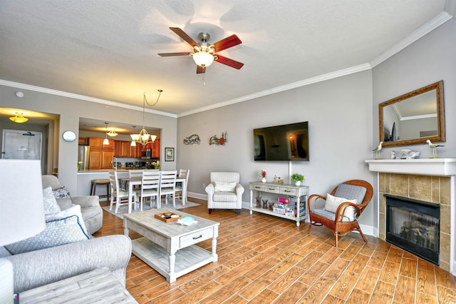 8121 Amalfi Pl Unit 7-805, Myrtle Beach, SC 29572 - living area featuring crown molding, a ceiling fan, a tile fireplace, baseboards, and light wood-style flooring