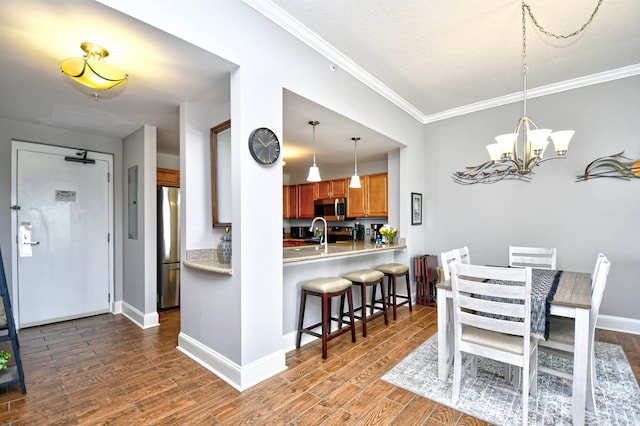 8121 Amalfi Pl Unit 7-805, Myrtle Beach, SC 29572 - dining area with crown molding, dark wood finished floors, a chandelier, and baseboards