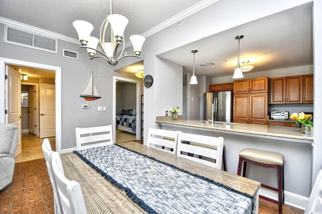 8121 Amalfi Pl Unit 7-805, Myrtle Beach, SC 29572 - dining space with ornamental molding, dark wood-type flooring, a chandelier, and baseboards