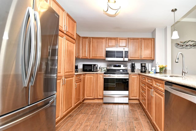 8121 Amalfi Pl Unit 7-805, Myrtle Beach, SC 29572 - kitchen with appliances with stainless steel finishes, a sink, wood finished floors, light stone countertops, and pendant lighting