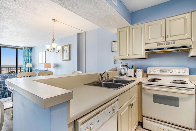 9400 Shore Dr Unit 124, Myrtle Beach, SC 29572 - kitchen with white appliances, under cabinet range hood, a sink, a peninsula, and cream cabinetry