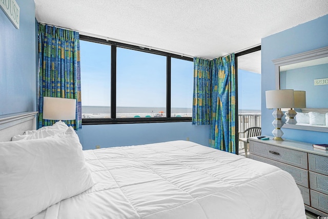 9400 Shore Dr Unit 124, Myrtle Beach, SC 29572 - bedroom featuring a water view and a textured ceiling