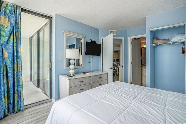 9400 Shore Dr Unit 124, Myrtle Beach, SC 29572 - bedroom featuring wood finished floors and a textured ceiling