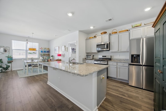 1723 Perthshire Loop, Myrtle Beach, SC 29579 - kitchen featuring stainless steel appliances, a sink, an island with sink, dark wood-style flooring, and baseboards