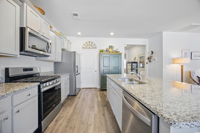 1723 Perthshire Loop, Myrtle Beach, SC 29579 - kitchen with appliances with stainless steel finishes, a sink, light wood-style flooring, recessed lighting, and light stone countertops