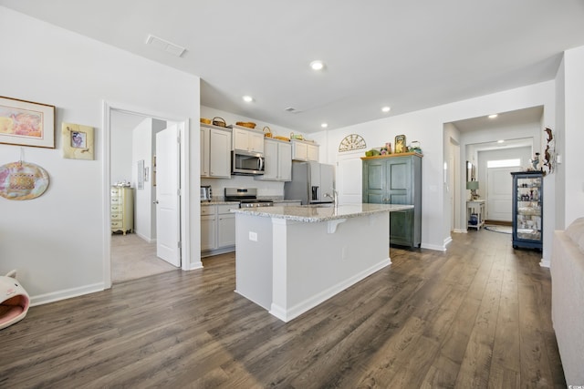 1723 Perthshire Loop, Myrtle Beach, SC 29579 - kitchen with appliances with stainless steel finishes, a kitchen island with sink, dark wood-type flooring, baseboards, and recessed lighting