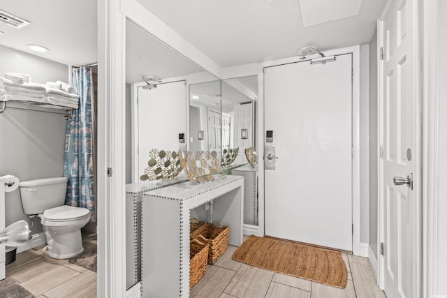 2500 N Ocean Blvd Ph 1, Myrtle Beach, SC 29577 - full bathroom with toilet, a skylight, wood finished floors, and curtained shower
