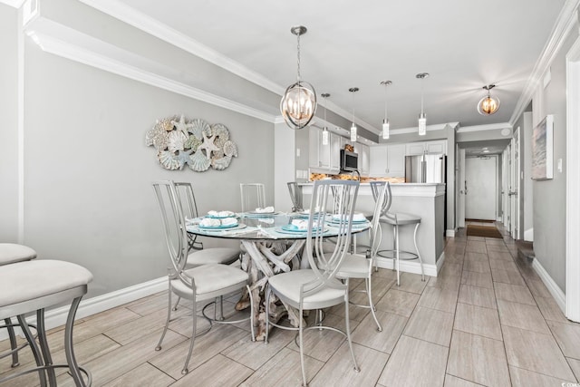 2500 N Ocean Blvd Ph 1, Myrtle Beach, SC 29577 - dining area featuring wood finish floors, baseboards, crown molding, and a chandelier