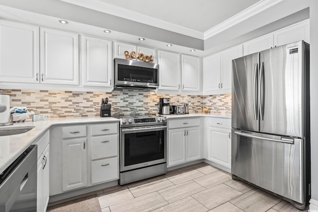 2500 N Ocean Blvd Ph 1, Myrtle Beach, SC 29577 - kitchen featuring stainless steel appliances, crown molding, light countertops, white cabinetry, and recessed lighting