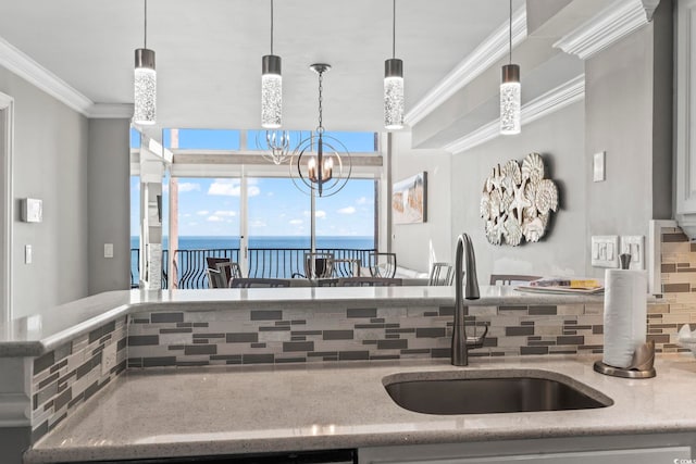 2500 N Ocean Blvd Ph 1, Myrtle Beach, SC 29577 - kitchen with a sink, decorative backsplash, ornamental molding, a water view, and light stone countertops