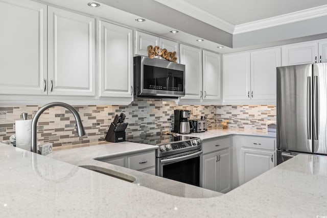 2500 N Ocean Blvd Ph 1, Myrtle Beach, SC 29577 - kitchen featuring appliances with stainless steel finishes, crown molding, white cabinetry, light stone countertops, and recessed lighting