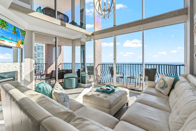 2500 N Ocean Blvd Ph 1, Myrtle Beach, SC 29577 - living room featuring a towering ceiling, a water view, a chandelier, a fireplace, and healthy amount of natural light