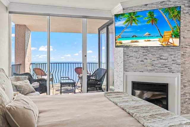 2500 N Ocean Blvd Ph 1, Myrtle Beach, SC 29577 - bedroom with access to outside, ornamental molding, a wall of windows, a glass covered fireplace, and multiple windows