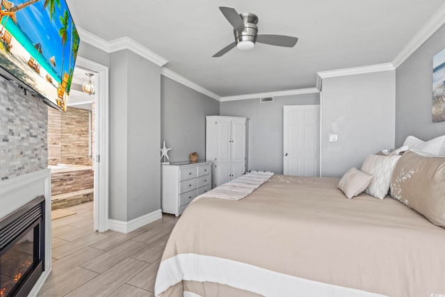 2500 N Ocean Blvd Ph 1, Myrtle Beach, SC 29577 - bedroom featuring wood finished floors, ornamental molding, baseboards, a ceiling fan, and a glass covered fireplace