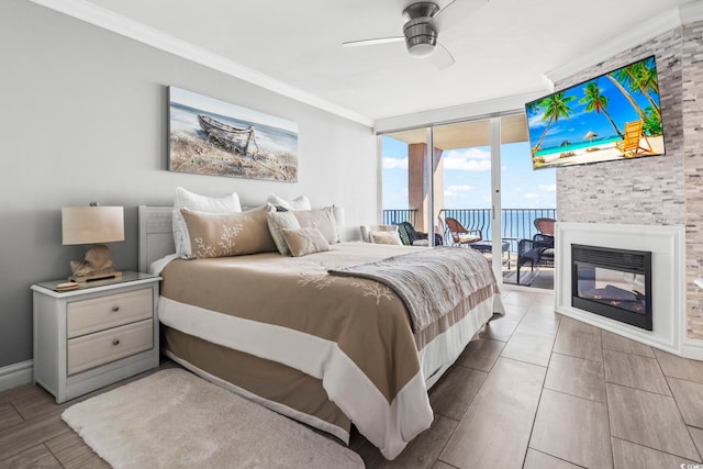 2500 N Ocean Blvd Ph 1, Myrtle Beach, SC 29577 - bedroom with access to exterior, ornamental molding, a wall of windows, wood finished floors, and a multi sided fireplace