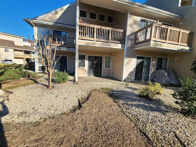 1025 W Plantation Dr W Unit 2817, Little River, SC 29566 - rear view of house featuring a balcony and a patio