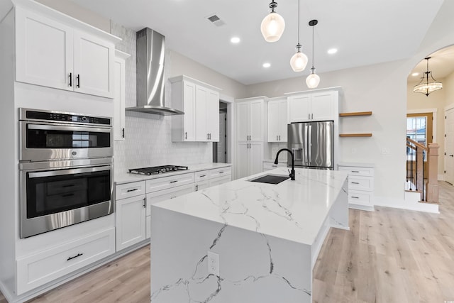 2205 Yellow Morel Way, Myrtle Beach, SC 29579 - kitchen featuring wall chimney range hood, a sink, stainless steel appliances, light wood-type flooring, and decorative backsplash